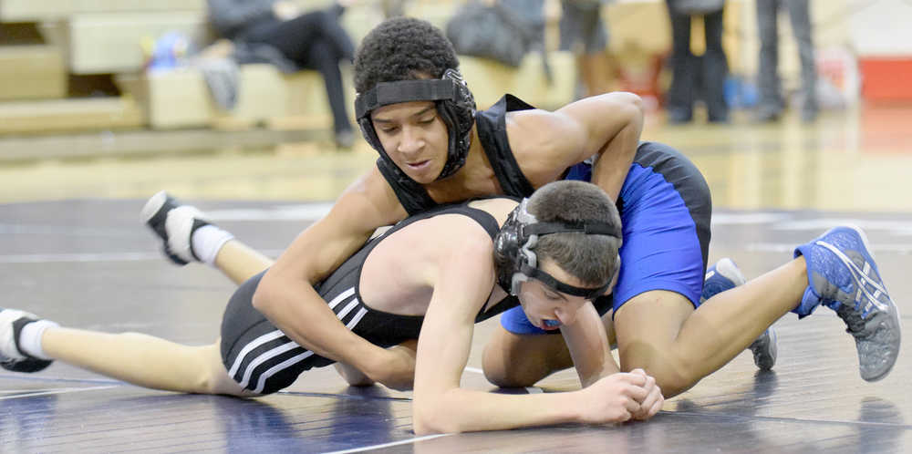 Photo by Jeff Helminiak/Peninsula Clarion Soldotna's Ben Booth controls Nikiski's Joey Yourkoski in an exhibition match at 106 pounds Wednesday at Soldotna Prep. Booth scored a 16-4 major decision.
