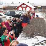 Photo by Megan Pacer/Peninsula Clarion Parents and children eagerly await Santa's arrival in a line that snakes to the end of the Kenai Chamber of Commerce and Visitor Center parking lot Friday, Nov. 25, 2016 in Kenai, Alaska. Santa has arrived at the center for the last three decades to take note of what local children want for Christmas.