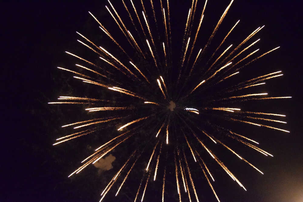 Photo by Megan Pacer/Peninsula Clarion A firework explodes in the sky above the Kenai Chamber of Commerce and Visitor Center during the finale of this year's Christmas Comes to Kenai celebration Friday, Nov. 25, 2016 in Kenai, Alaska.