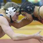 Photo by Jeff Helminiak/Peninsula Clarion Soldotna's Bechler Metcalf and Kenai Central's Keyshawn McEnerney tie up at 152 pounds at Kenai Central High School on Thursday. Metcalf scored a 10-4 victory.