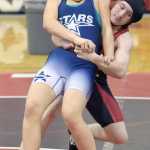 Photo by Jeff Helminiak/Peninsula Clarion Soldotna's Amanda Wylie tries to fight off a takedown attempt by Kenai Central's Keaton Logston at Kenai Central High School on Thursday. Logston won the match by injury default.