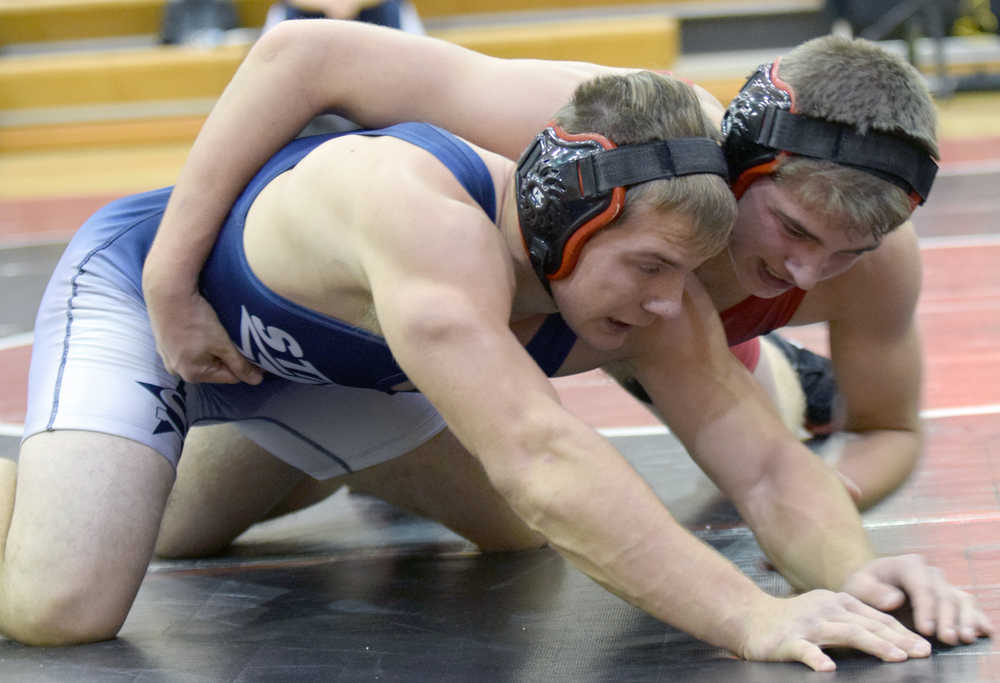 Photo by Jeff Helminiak/Peninsula Clarion Kenai Central's Byron Dunham tries to control Soldotna's Austin Schrader at 195 on Thursday at Kenai Central High School. Schrader scored a 6-4 sudden victory.