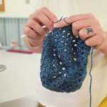 Photo by Megan Pacer/Peninsula Clarion A woman crochets a teal hat during a session of the Wildwood Correctional Complex's inmate crochet program Tuesday, Nov. 29, 2016 at the complex's pretrial building in Kenai, Alaska.
