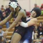 Photo by Joey Klecka/Peninsula Clarion Soldotna's Amanda Wylie grabs Teeana Nicholai of Wasilla in Saturday's 145-pound girls championship at the Northern Lights Conference tournament at Kenai Central HIgh School.