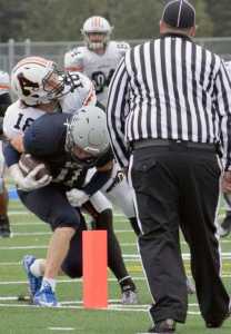 Photo by Jeff Helminiak/Peninsula Clarion Soldotna's Brenner Furlong squeezes past West's Will Troxel into the end zone for a third-quarter touchdown Friday at Justin Maile Field in Soldotna. The Stars won 49-30.