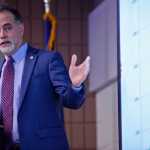 Ben Boettger/Peninsula Clarion Senator Peter Micciche (R-Soldotna) gestures at a graph of state economic data while presenting to members of the Kenai and Soldotna Chambers of Commerce on Tuesday, Dec. 13 at the Soldotna Regional Sports Complex.