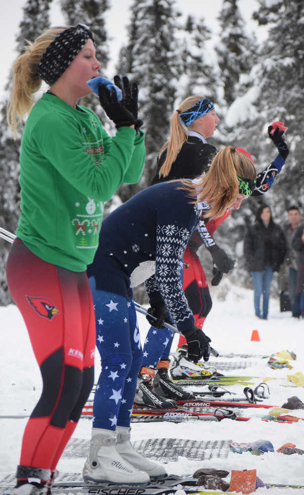 Photo by Joey Klecka/Peninsula Clarion A row of Kenai Central and Soldotna skiers armed with bean bags take aim at a line of trash bins Friday afternoon at the Tsalteshi ski trails in Soldotna.