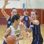 Photo by Jeff Helminiak/Peninsula Clarion Homer's Kailee Veldstra tries to get out of the trap set by Soldotna's Danica Schmidt and Aliann Schmidt on Friday at Kenai Central High School.