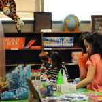Photo by Elizabeth Earl/Peninsula Clarion A Soldotna Elementary School student peruses the items available in the holiday gift shop put on by the school's Parent-Teacher Organization in the library on Wednesday, Dec. 14, 2016 in Soldotna, Alaska.