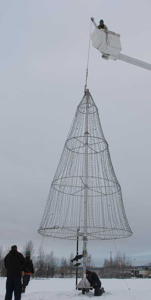 HEA's boom truck sets the Soldotna tree on its perch.