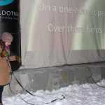 Hannah Taurianen leads the crowd in caroling at Christmas in the Park.