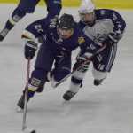 Photo by Joey Klecka/Peninsula Clarion Homer's Ethan Pitzman vies for control of the puck against Soldotna's Wyatt Medcoff (16), Thursday evening at the Soldotna Regional Sports Complex.