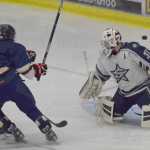 Photo by Joey Klecka/Peninsula Clarion Soldotna goaltender Billy Yoder wards off a shot from Homer forward Dimitry Kuzmin, Thursday evening at the Soldotna Regional Sports Complex.