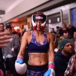 Photo by Ben Boettger/Peninsula Clarion Boxer Megan Anderson makes her way to the ring to face Robyn Sullens in the Fight Before Christmas martial arts event on Thursday, Dec. 22, 2016 at Soldotna's Peninsula Center Mall.