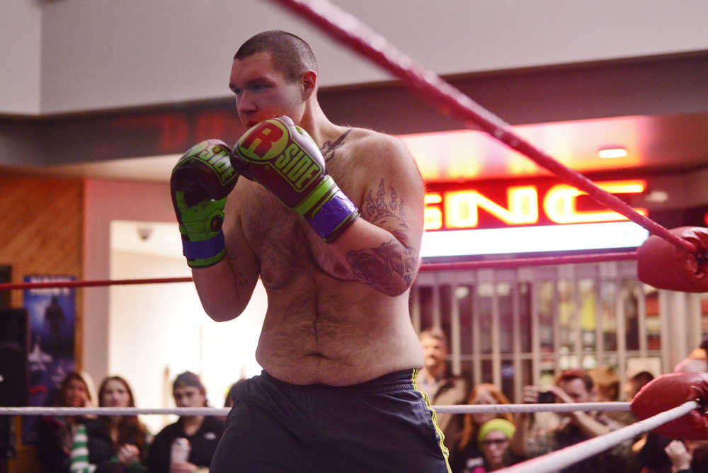 Ben Boettger/Peninsula Clarion Boxer Quinton Kennedy stands ready in his match against Doug Machado in the Fight Before Christmas martial arts event on Thursday, Dec. 22 at Soldotna's Peninsula Center mall.