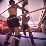 Ben Boettger/Peninsula Clarion Kickboxers Jay Harris and Codyne Williams (left) fight in the main event of the Fight Before Christmas martial arts event on Thursday, Dec. 22 at Soldotna's Peninsula Center Mall. Harris beat Williams by decision of the judges.