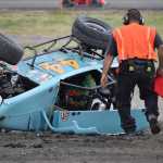 Photo by Joey Klecka/Peninsula Clarion A Twin City Raceway safety worker rushes to the aid of Legends driver Ty Torkelson, who went for a wild ride, July 23 at the track. Torkelson got out of his car and walked away.