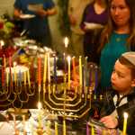 Ben Boettger Members of the Kenai peninsula's Briate Elohim Jewish congregation sing while lighting a collection of menorahs during a Hanukkah celebration at the home of member Allison Gottesman on Friday Dec. 30. This past Sunday was the last day of Hanukkah.
