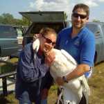 Photo courtesy John Morton, Kenai National Wildlife Refuge George Pollard holds an orphaned cygnet rescued from a local lake along with two siblings before they were relocated to Iowa in 2005. One of the cygnets, No. 69, has returned to the pond where it was raised by volunteer Laurie Severe.