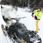 Photo courtesy Laurie Speakman This photos taken Tuesday, Jan. 3, 2017 on Kalifornsky Beach Road between Kenai and Soldotna shows Laurie Speakman, a volunteer driver for the Alaska Moose Federation on the Kenai Peninsula, putting out a snowmobile fire. She used two fire extinguishers to subdue the flames, one from home and one from her truck used to salvage moose, when she noticed a teen in distress on the side of the road.