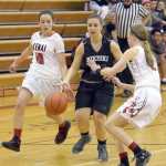 Photo by Jeff Helminiak/Peninsula Clarion Kenai Central's Rebecca Miller taps the ball from Nikiski's Kelsey Clark as Kenai Central's Jaycie Calvert looks on Thursday at Kenai Central High School.
