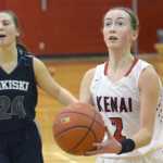Photo by Jeff Helminiak/Peninsula Clarion Kenai Central's Jaycie Calvert gets by Nikiski's Kelsey Clark and the rest of the defense for a layup Thursday at Kenai Central.