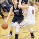 Photo by Jeff Helminiak/Peninsula Clarion Nikiski's Bethany Carstens drives the baseline against Kenai Central's Bethany Coghill on Thursday at Kenai Central High School.