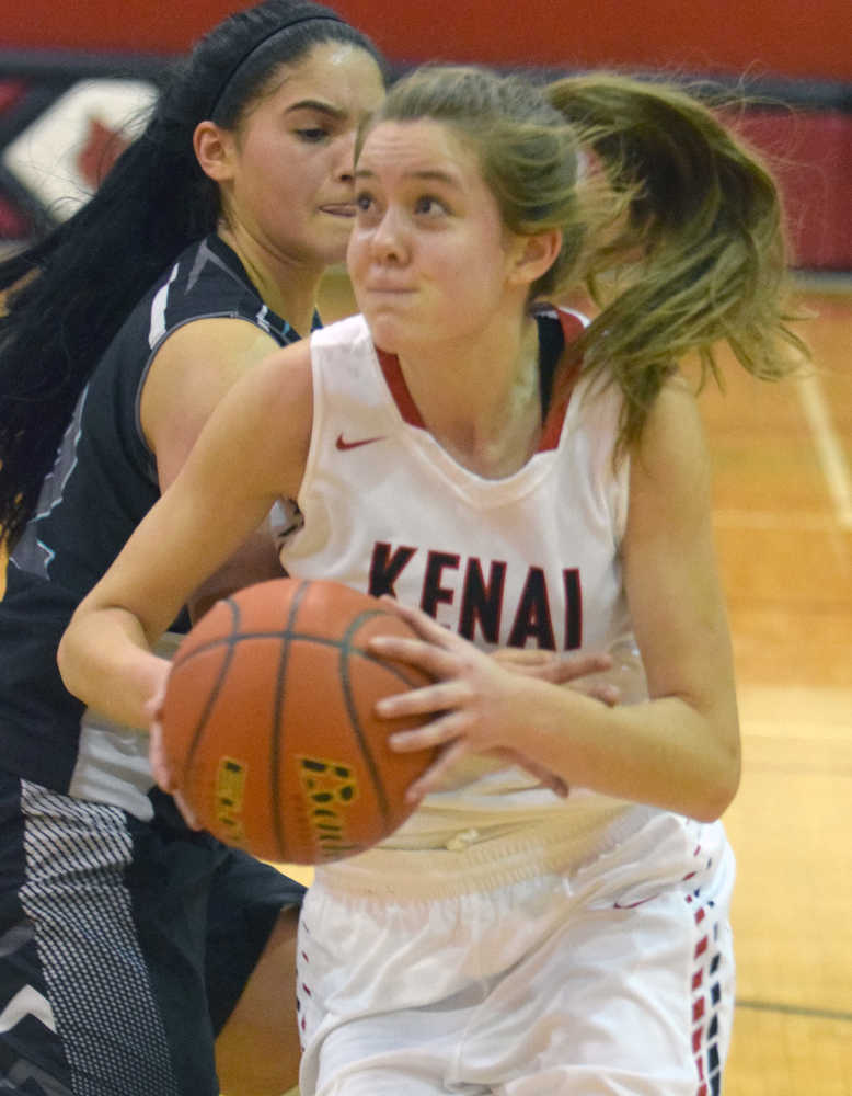 Photo by Jeff Helminiak/Peninsula Clarion Kenai Central's Rebecca Satathite gets past Nikiski's Brianna Vollertsen on Thursday at Kenai Central High School.