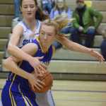 Photo by Joey Klecka/Peninsula Clarion Soldotna sophomore Brittani Blossom looks for an open teammate amidst a hoard of Kodiak defenders Saturday at the Soldotna Prep gymnasium.