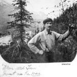 Dear old Tom just as he was looking southeast, circa August 1898. Tom Brackett standing on the west side of the Skagway River Valley with the valley floor below and the mountains surrounding Skagway behind him. Tom Brackett died of Typhoid fever on Feb. 26, 1901 in Portsmouth, New Hampshire. This note indicates that Mollie Brackett probably assembled her album sometime after Toms death. (Courtesy Photo | National Park Service, Klondike Gold Rush National Historical Park, Brackett Family Collection, BRWHP184, KLGO WP-23-5366.)
