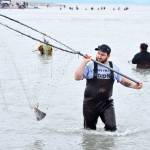 Michael Pate of Soldotna hoists a sockeye salmon out of the Kasilof River on Tuesday, July 31, 2018 in Kasilof, Alaska. (Photo by Elizabeth Earl/Peninsula Clarion)