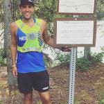 Pete Kostelnick stands next to a sign on Skilak Lake Road in a recent undated photo. (Photo provided by Pete Kostelnick)