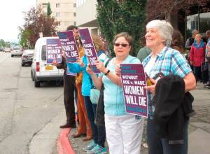 Carole Shay, right, and Gwen Helms participate in a protest outside U.S. Sen. Lisa Murkowskis office Monday, July 9, 2018, in Anchorage, Alaska. Protesters rallied to urge Murkowski to vote against President Donald Trumps Supreme Court nominee. (AP Photo/Rachel DOro)