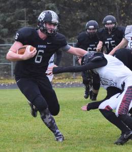 Nikiski junior Cody Handley (6) stiff arms Eielson defender Jeremiah Brown Sept. 23, 2017, at Nikiski High School. (Photo by Joey Klecka/Peninsula Clarion)