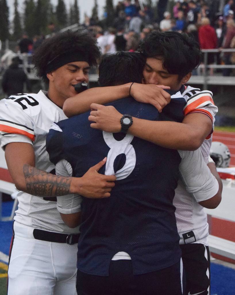 Soldotna junior Aaron Faletoi (8) is comforted by West player Zach Tiu following SoHis loss to West, Friday at Justin Maile Field in Soldotna. (Photo by Joey Klecka/Peninsula Clarion)