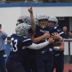 Soldotna junior Jersey Truesdell (pointing) is mobbed by teammates after scoring a touchdown Friday against West Anchorage at Justin Maile Field in Soldotna. (Photo by Joey Klecka/Peninsula Clarion)