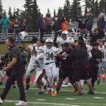 West football players and fans celebrate on field after defeating Soldotna 18-13 Friday at Justin Maile Field in Soldotna. (Photo by Joey Klecka/Peninsula Clarion)
