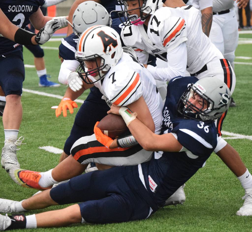 Soldotna junior Zach Ziegler tackles West running back Lewis Malala Jr. Friday at Justin Maile Field in Soldotna. (Photo by Joey Klecka/Peninsula Clarion)
