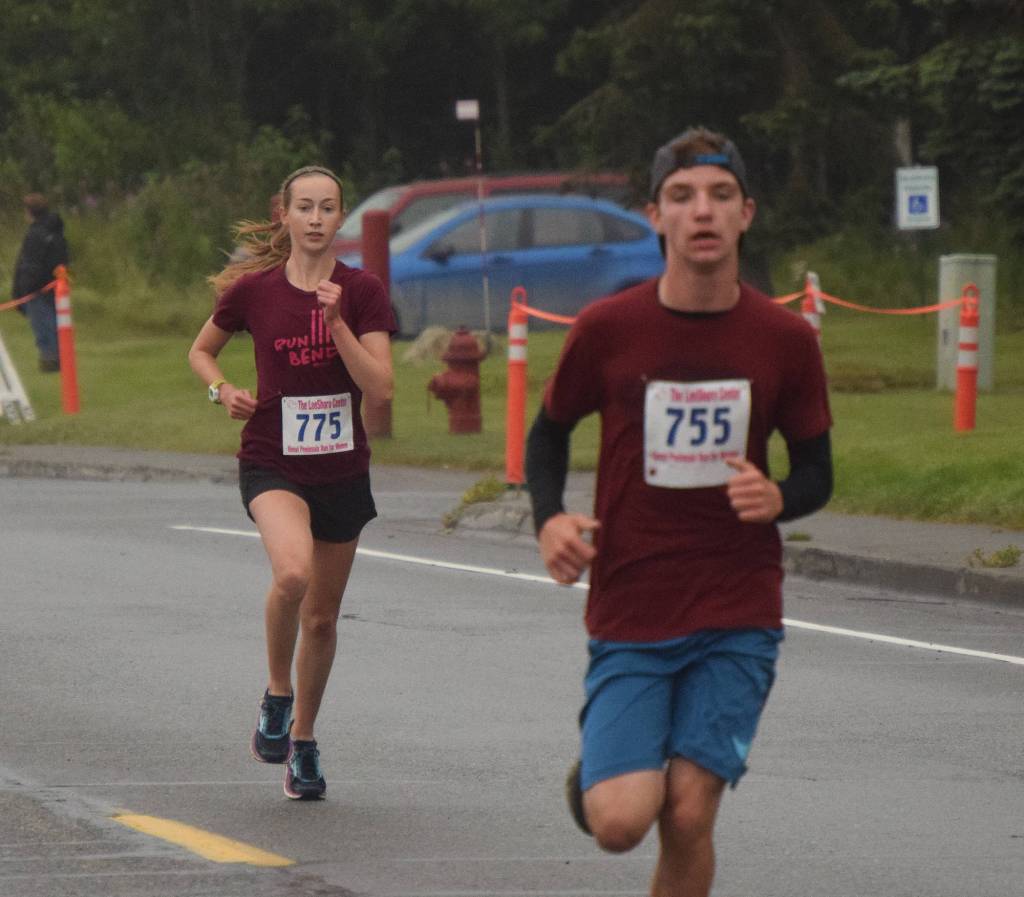 Womens 5K winner Jaycie Calvert (775) and boys winner Tyler Johnson approach the finish line Saturday morning in the 31st annual LeeShore Center Run for Women in Kenai. (Photo by Joey Klecka/Peninsula Clarion)