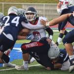 North Pole senior Bradley Antesberger (9) gets wrapped up by Soldotna defensive backs Cam Johnson (24) and Levi Benner (61) Friday at Soldotnas Justin Maile Field. (Photo by Joey Klecka/Peninsula Clarion)