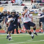 Soldotna junior Wyatt Medcoff (7) bursts through a hole after intercepting a pass Friday against North Pole at Soldotnas Justin Maile Field. (Photo by Joey Klecka/Peninsula Clarion)