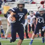 Soldotna junior Wyatt Medcoff looks for room to run after grabbing an interception Friday against North Pole at Soldotnas Justin Maile Field. (Photo by Joey Klecka/Peninsula Clarion)