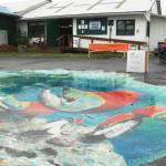 A mural decorates the pavement at the Kenai Peninsula Fairgrounds at the fair on Saturday, Aug. 18, 2018 in Ninilchik, Alaska. (Photo by Elizabeth Earl/Peninsula Clarion)