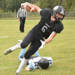 Nikiski senior Cody Handley sheds a Valdez tackler en route to picking up a first down Saturday at Nikiski High School. (Photo by Joey Klecka/Peninsula Clarion)