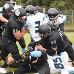 Valdez junior Owen Chadwick (3) runs into a wall of Nikiski defenders including Koleman McCaughey (50), Dustin Mullins (62) and Simon Grenier (28) Saturday at Nikiski High School. (Photo by Joey Klecka/Peninsula Clarion)