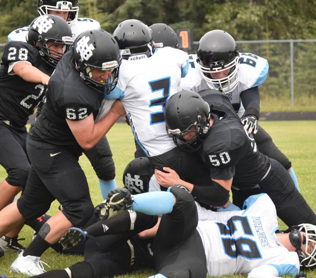 Valdez junior Owen Chadwick (3) runs into a wall of Nikiski defenders including Koleman McCaughey (50), Dustin Mullins (62) and Simon Grenier (28) Saturday at Nikiski High School. (Photo by Joey Klecka/Peninsula Clarion)