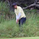 Birch Ridges Pedro McCall hacks out of the thick grass behind the 15th green Sunday, Aug. 19, 2018, during the Peninsula Cup at Kenai Golf Course. (Photo by Jeff Helminiak/Peninsula Clarion)