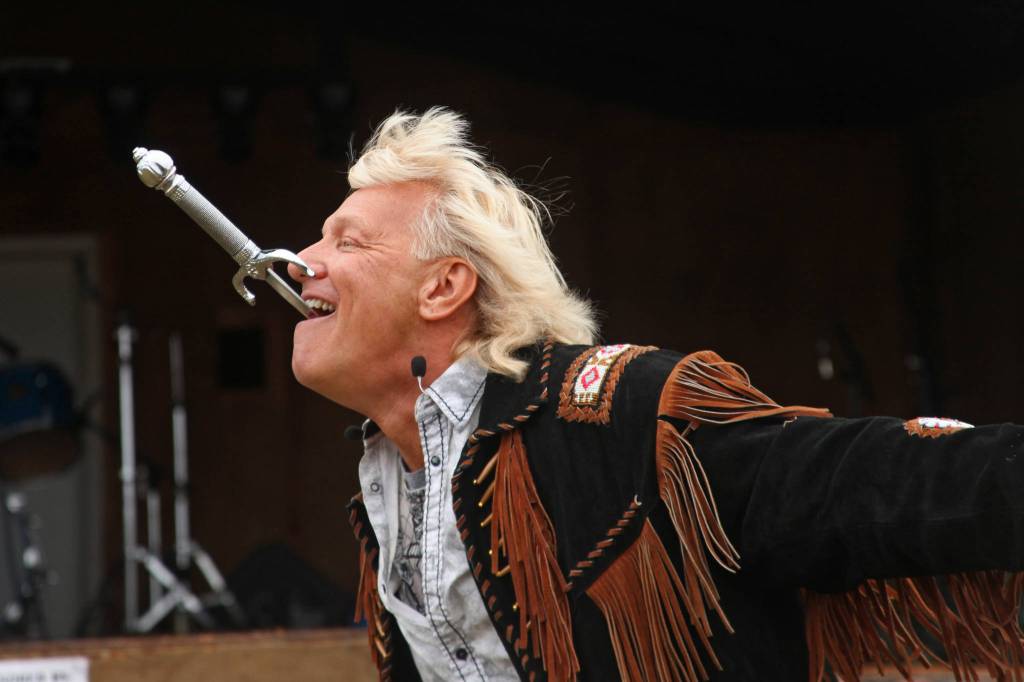 Sword swallower Dan Meyer demonstrates the technique during a show at the Kenai Peninsula Fair on Saturday, August 18, 2018 in Ninilchik, Alaska. (Photo courtesy Ben Boettger)
