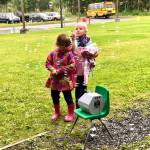 Two students play in the bubbles that greeted them on their first day of school on Tuesday, Aug. 21, 2018, at Mountain View Elementary in Kenai, Alaska. (Photo by Victoria Petersen/Peninsula Clarion)