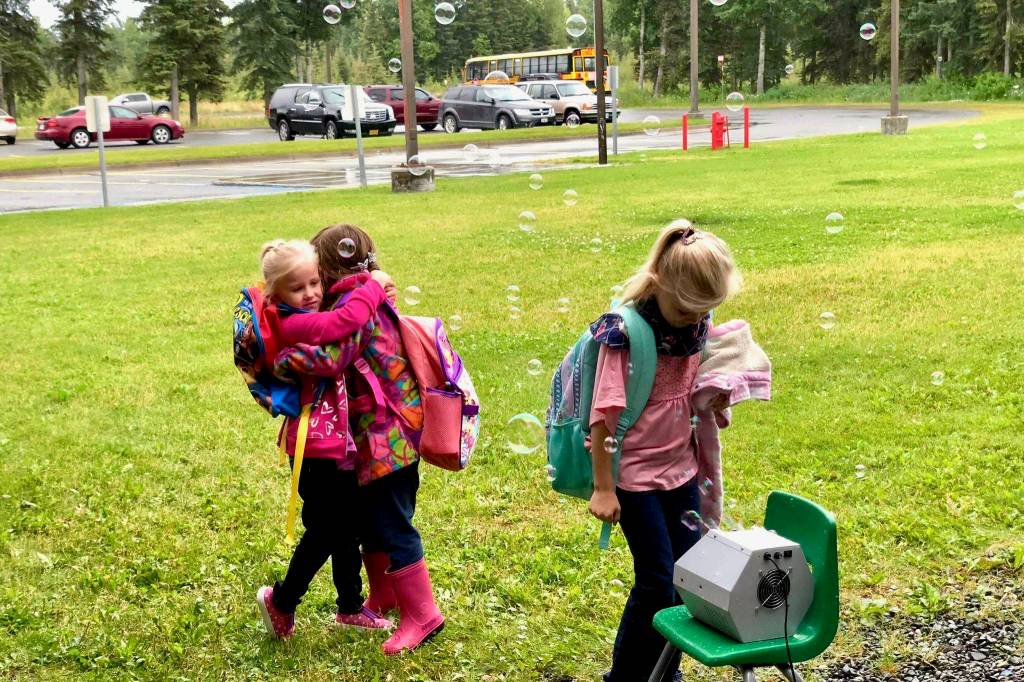 Friends unite on the first day of school, Tuesday, Aug. 21, 2018, at Mountain View Elementary in Kenai, Alaska. (Photo by Victoria Petersen/Peninsula Clarion)